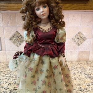 Elegant Porcelain Doll with Red and Cream Flowered Dress